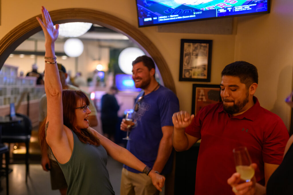 Three friends laughing and dancing at a 35th-birthday celebration at Electric Shuffle in Austin