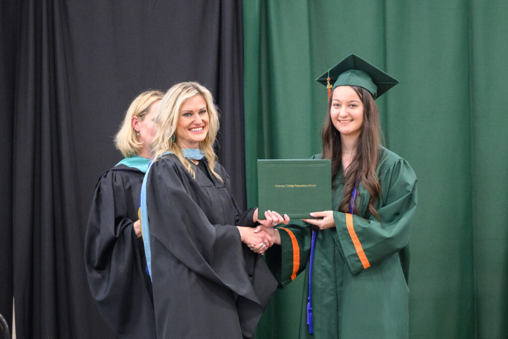Graduation ceremony, diploma handoff